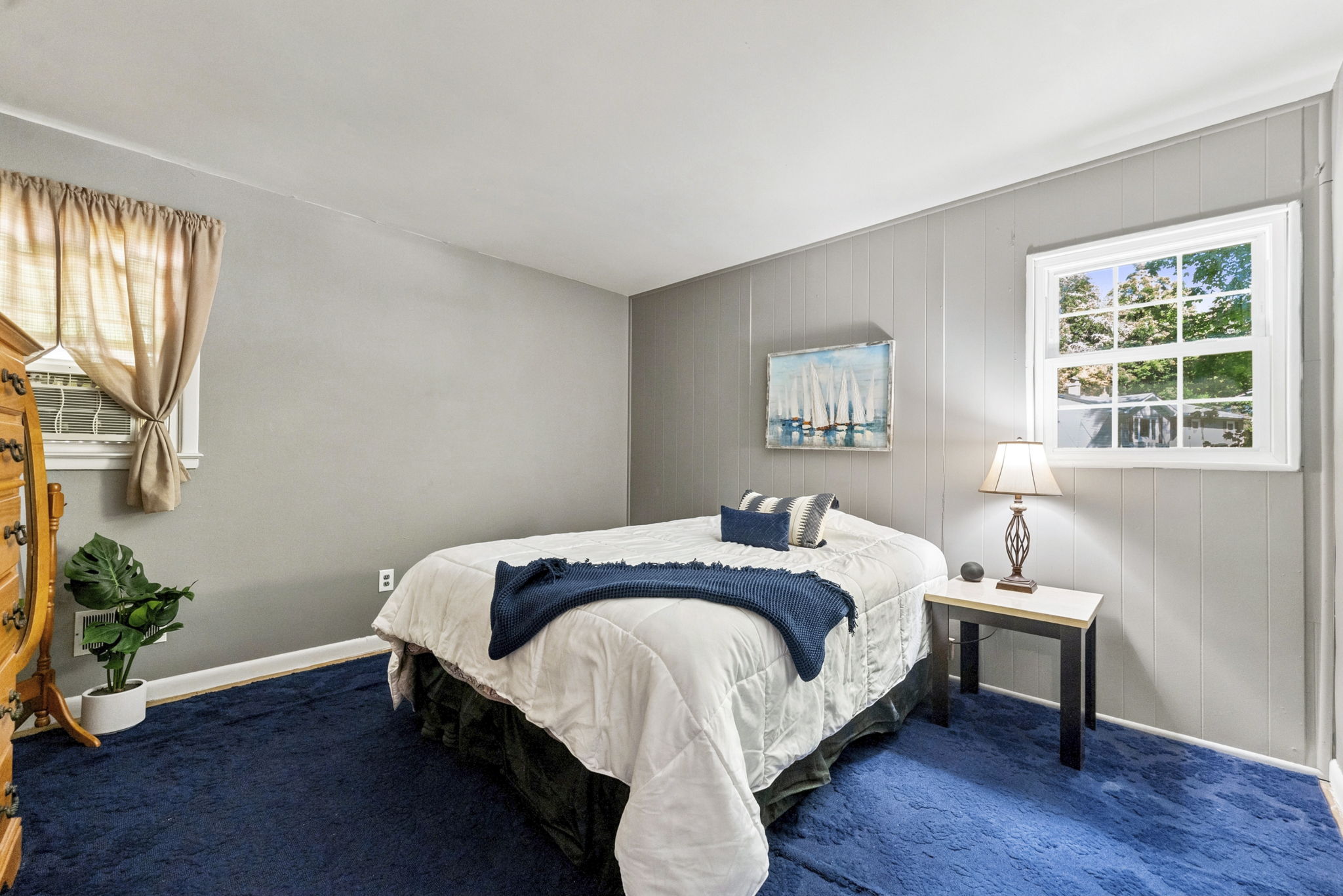 Hardwood floors are believed to be beneath the bedroom carpeting, offering additional potential.