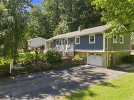Set beneath a beautiful weeping cherry tree on a quiet Vernon cul-de-sac, 18 Fox Hollow Court offers charming curb appeal and easy ranch-style living. Its soft blue exterior and tree-lined backyard create a peaceful, private setting.