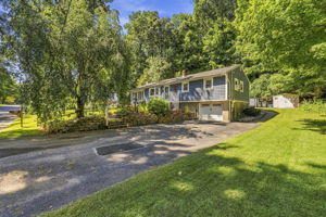 Set beneath a beautiful weeping cherry tree on a quiet Vernon cul-de-sac, 18 Fox Hollow Court offers charming curb appeal and easy ranch-style living. Its soft blue exterior and tree-lined backyard create a peaceful, private setting.