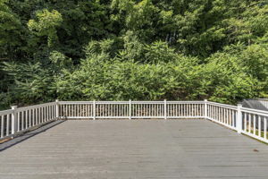 Sliding doors open to an impressive 25-by-25-foot deck. Step down to a patio. Surrounded by mature trees, the backyard offers privacy for outdoor dining, entertaining or simply relaxing.