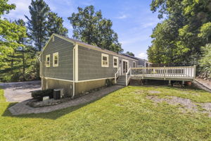 Sliding doors open to an impressive 25-by-25-foot deck. Step down to a patio. Surrounded by mature trees, the backyard offers privacy for outdoor dining, entertaining or simply relaxing.