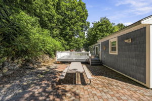 Sliding doors open to an impressive 25-by-25-foot deck. Step down to a patio. Surrounded by mature trees, the backyard offers privacy for outdoor dining, entertaining or simply relaxing.