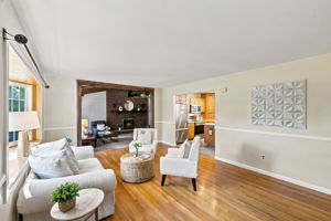 A freshly painted living room features beautiful hardwood floors and abundant natural light.
