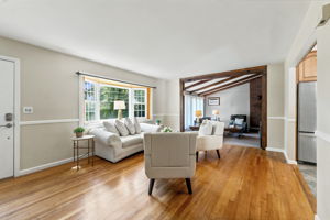 A freshly painted living room features beautiful hardwood floors and abundant natural light.