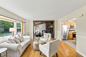 A freshly painted living room features beautiful hardwood floors and abundant natural light.