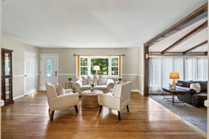 A freshly painted living room features beautiful hardwood floors and abundant natural light.