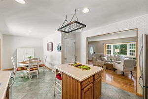 The large eat-in kitchen provides plenty of room to cook and gather, with a center island and sliding doors opening to an impressive 25-by-25-foot deck.
