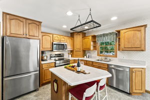 The large eat-in kitchen provides plenty of room to cook and gather, with a center island and sliding doors opening to an impressive 25-by-25-foot deck.