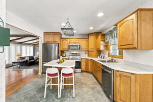 The large eat-in kitchen provides plenty of room to cook and gather, with a center island and sliding doors opening to an impressive 25-by-25-foot deck.