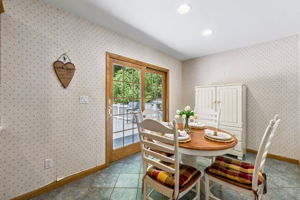 The large eat-in kitchen provides plenty of room to cook and gather, with a center island and sliding doors opening to an impressive 25-by-25-foot deck.