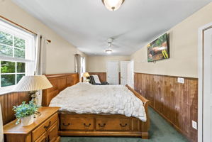 Currently being used as the primary with two sets of closets! Hardwood floors are believed to be beneath the bedroom carpeting, offering additional potential. Previously this was 2 bedrooms, can be converted back.