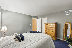 Hardwood floors are believed to be beneath the bedroom carpeting, offering additional potential.