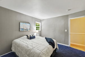 Hardwood floors are believed to be beneath the bedroom carpeting, offering additional potential.
