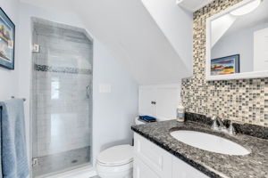 Primary new full bath, walk-in glass shower door with tile surround