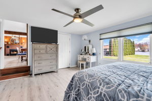 1st floor primary bedroom with lakeview's and access out onto the patio