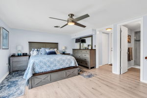 Spacious primary with view to private full bath and walk-in closet