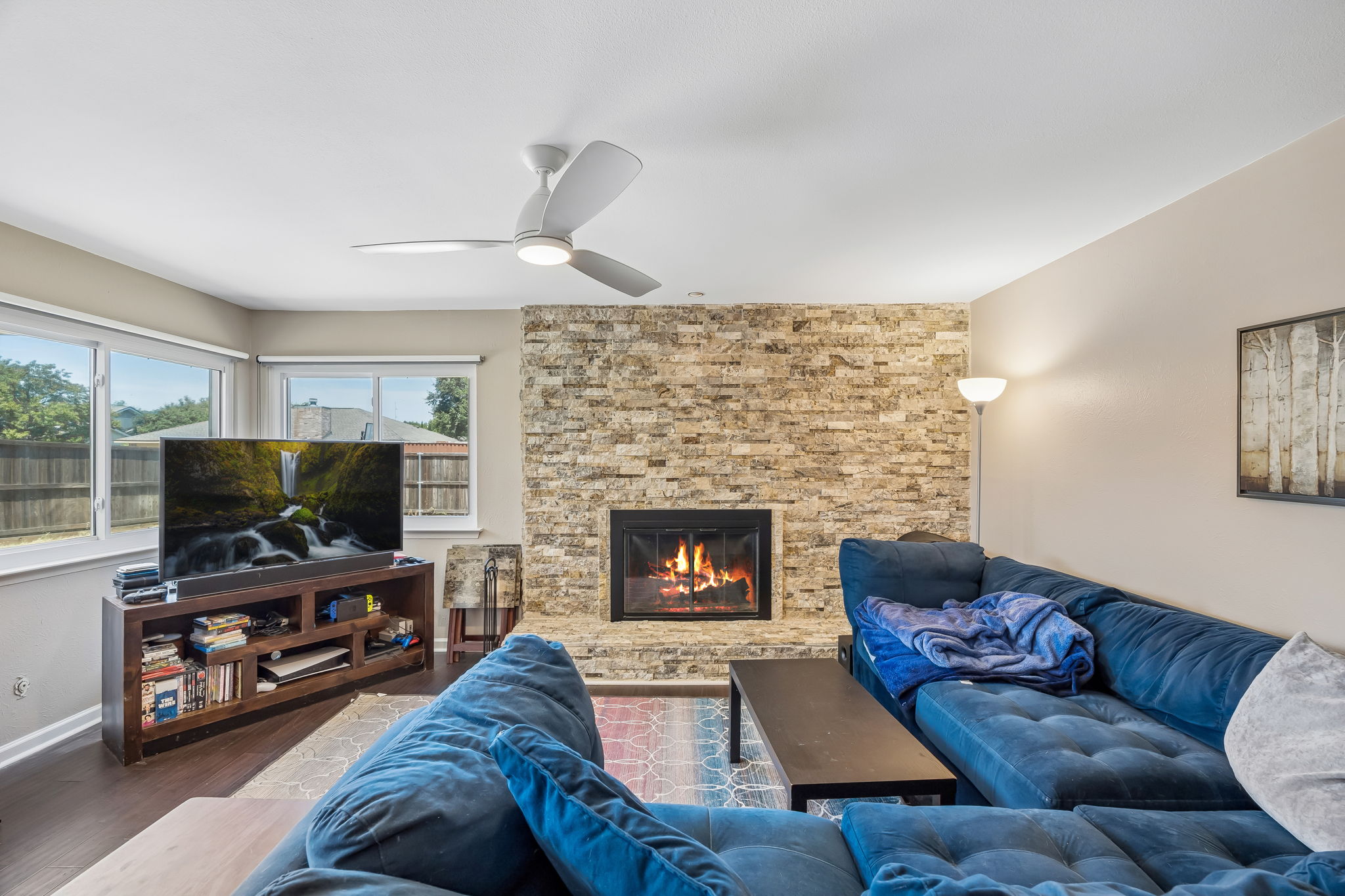 Cozy stacked stone fireplace in open living room