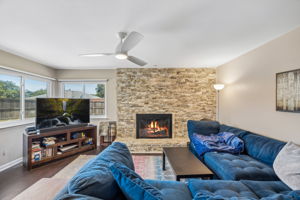 Cozy stacked stone fireplace in open living room