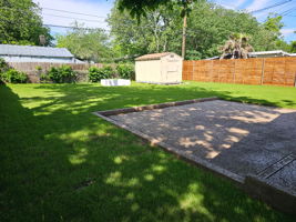 Good size fenced backyard with a patio area and a Tuff Shed (8x12).