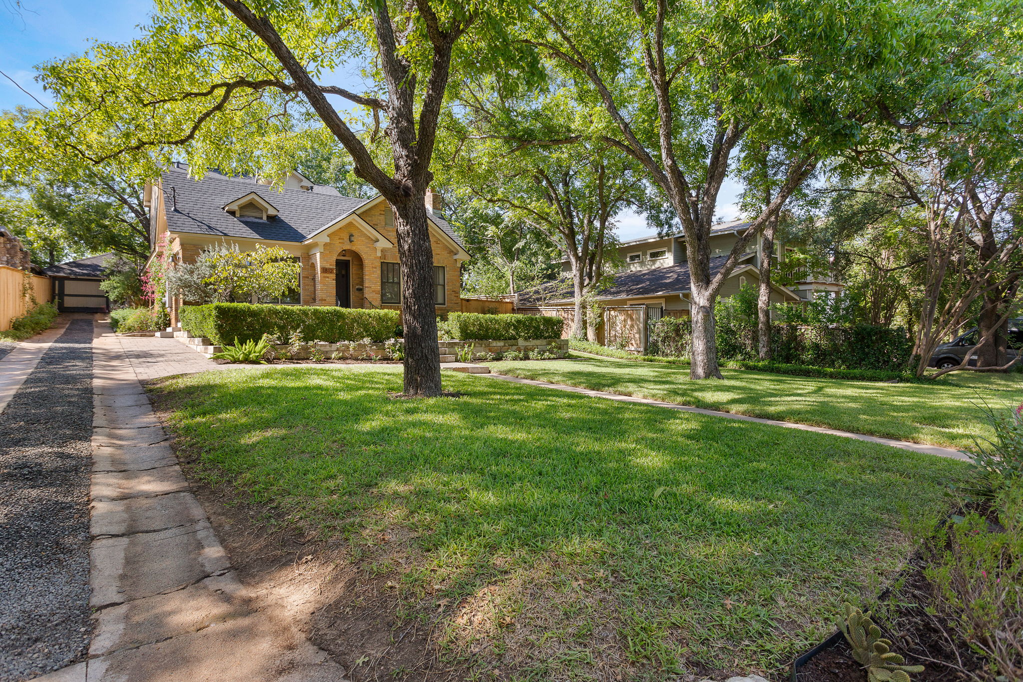 Large front yard and long driveway to detached garage.