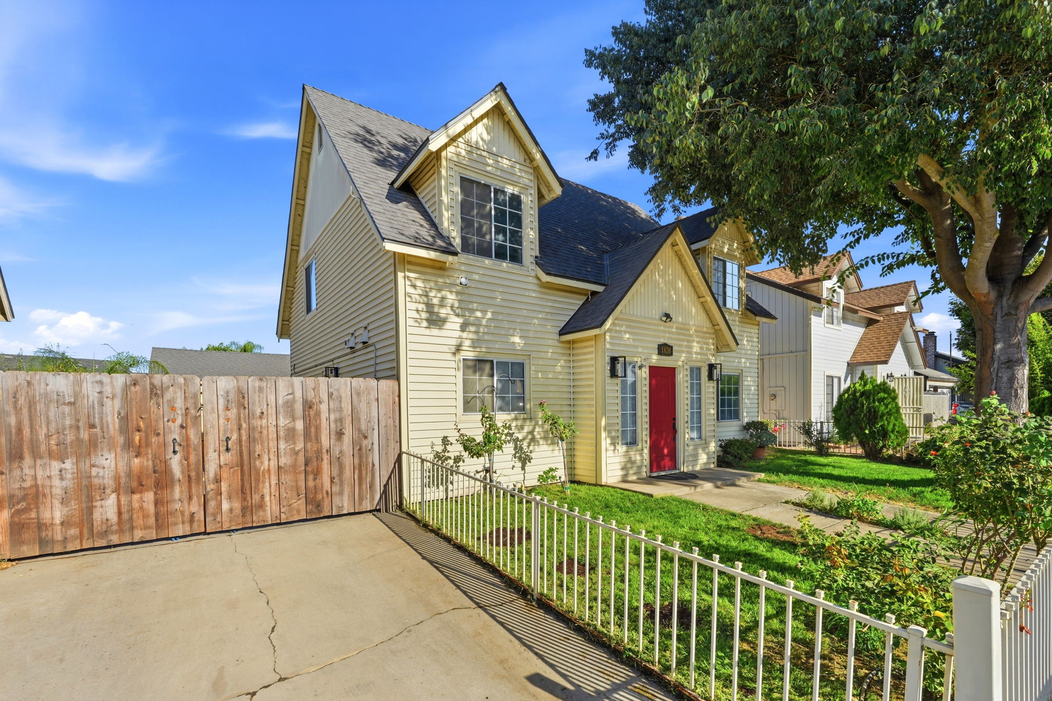 Front and side exterior with gated driveway access
