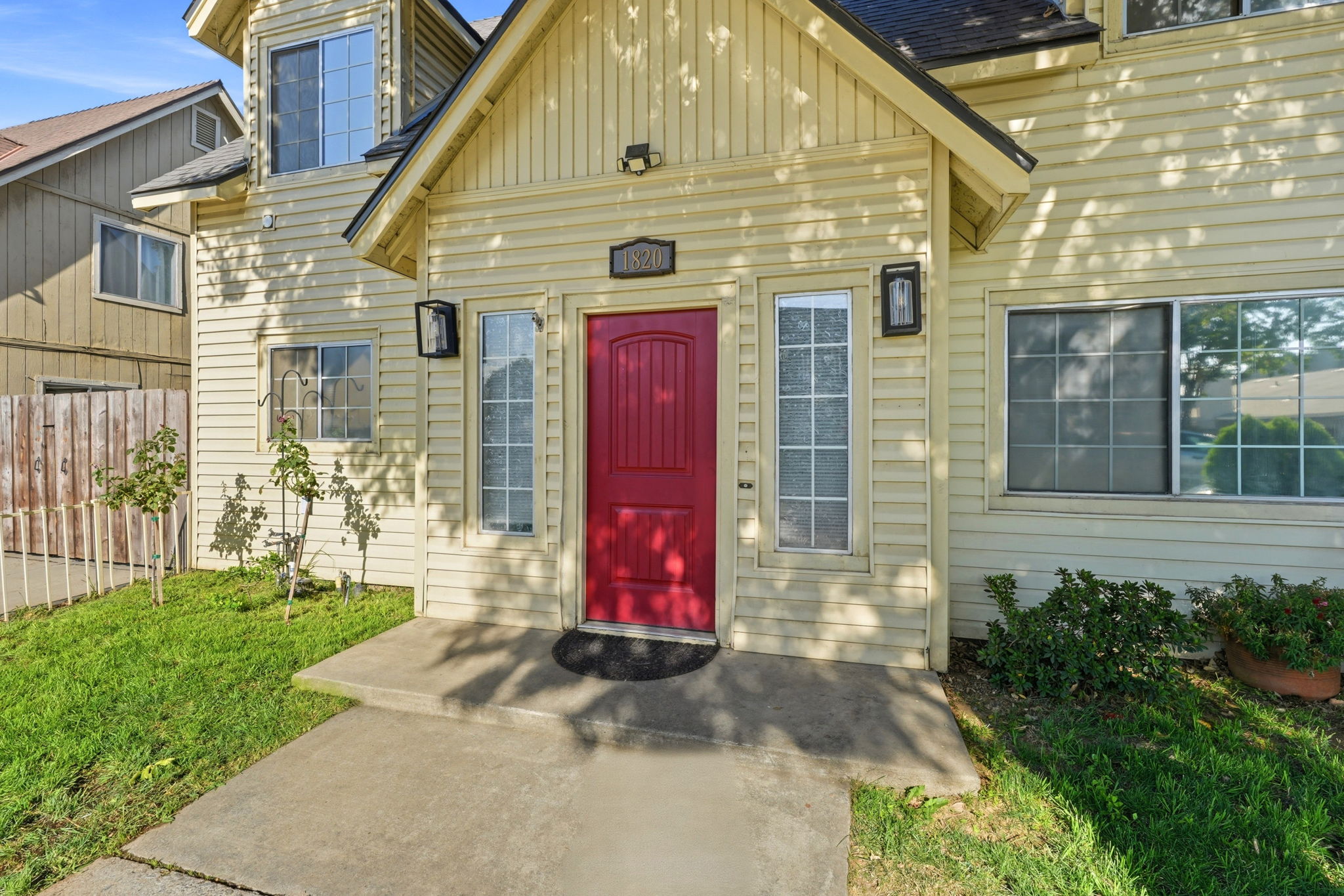 Covered front entry with distinctive red door