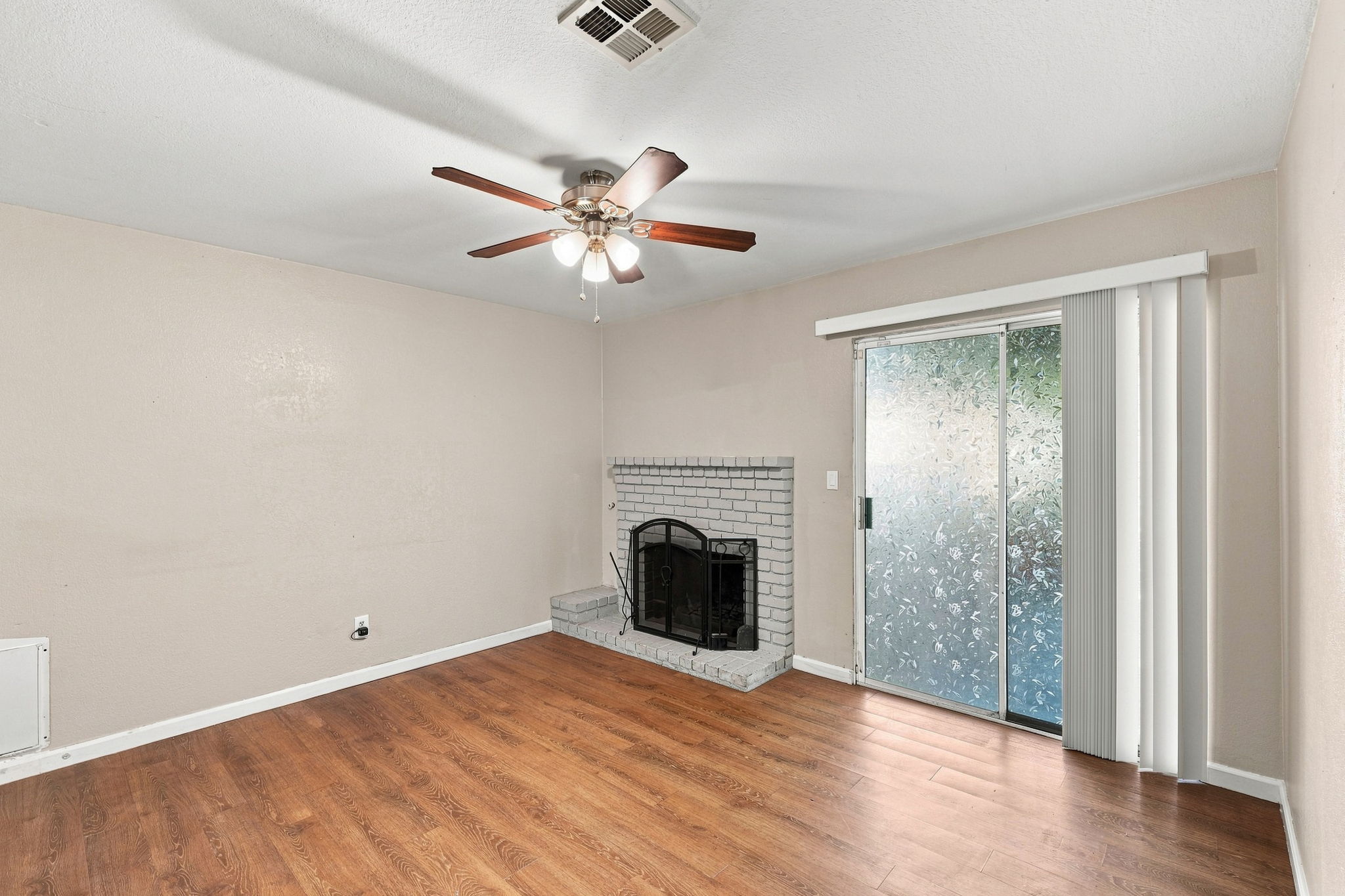 Living room with fireplace and sliding patio door