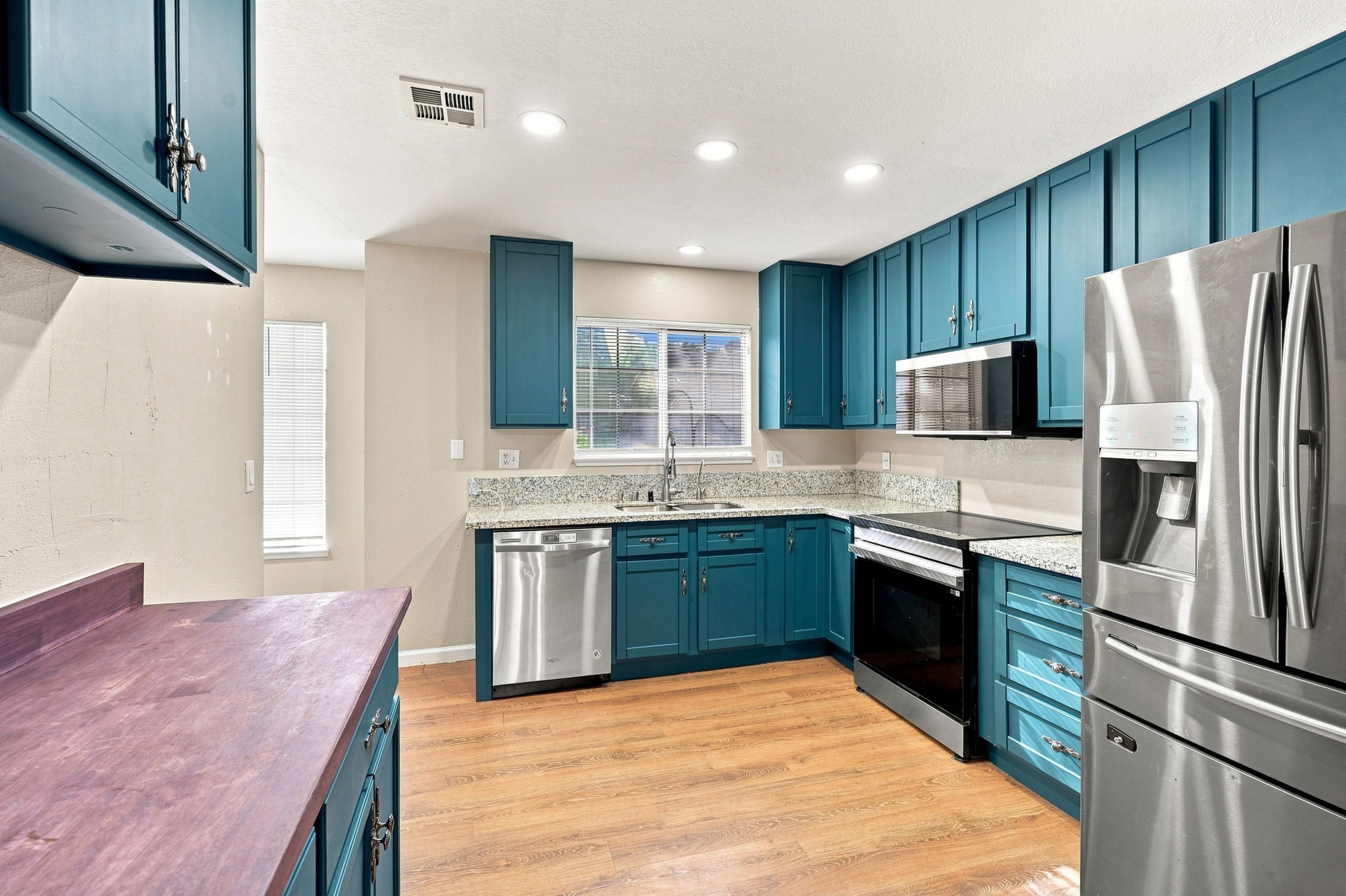Kitchen with stainless-steel appliances and recessed lighting