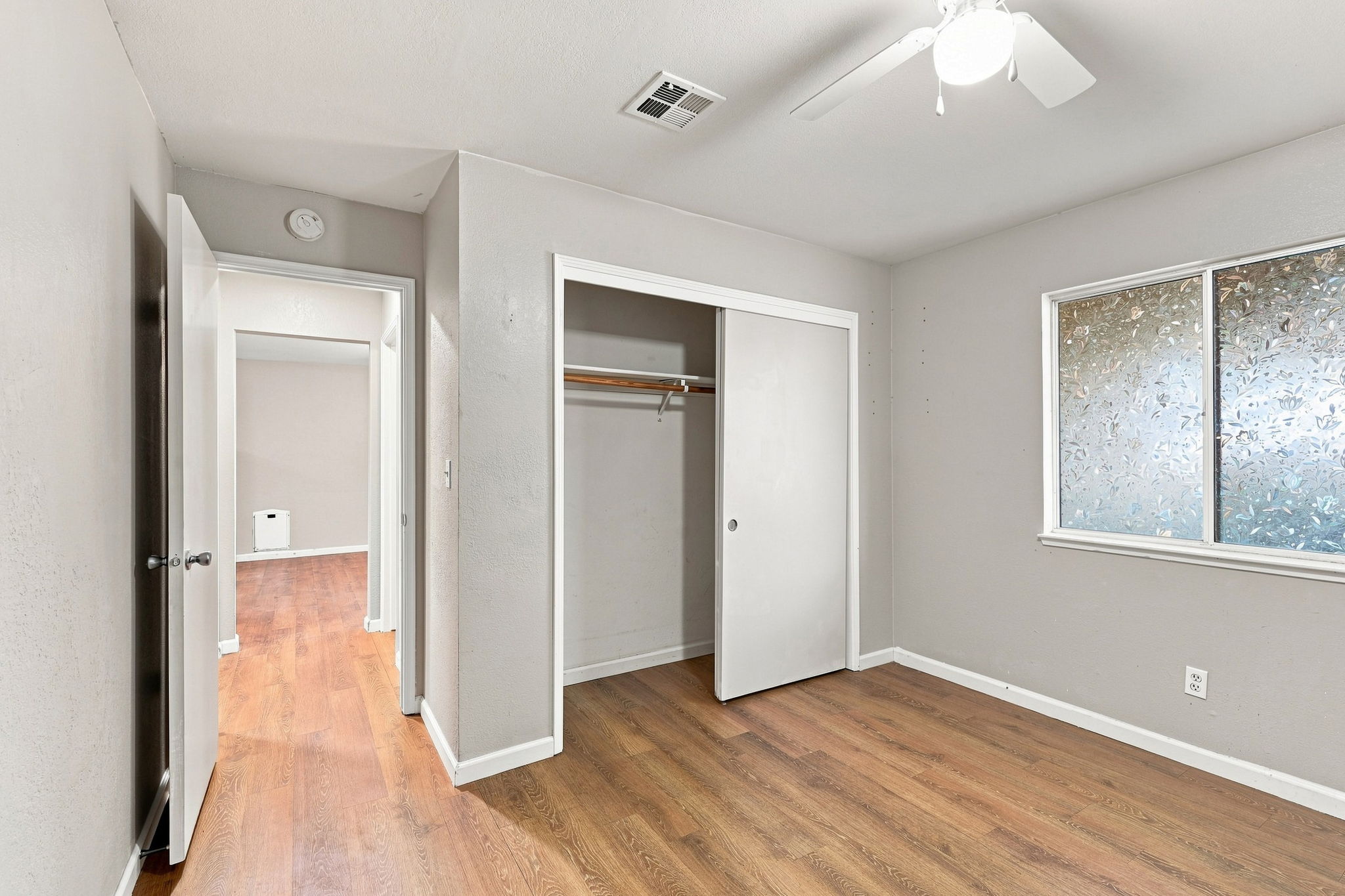 Downstairs Bedroom 1 with sliding-door closet