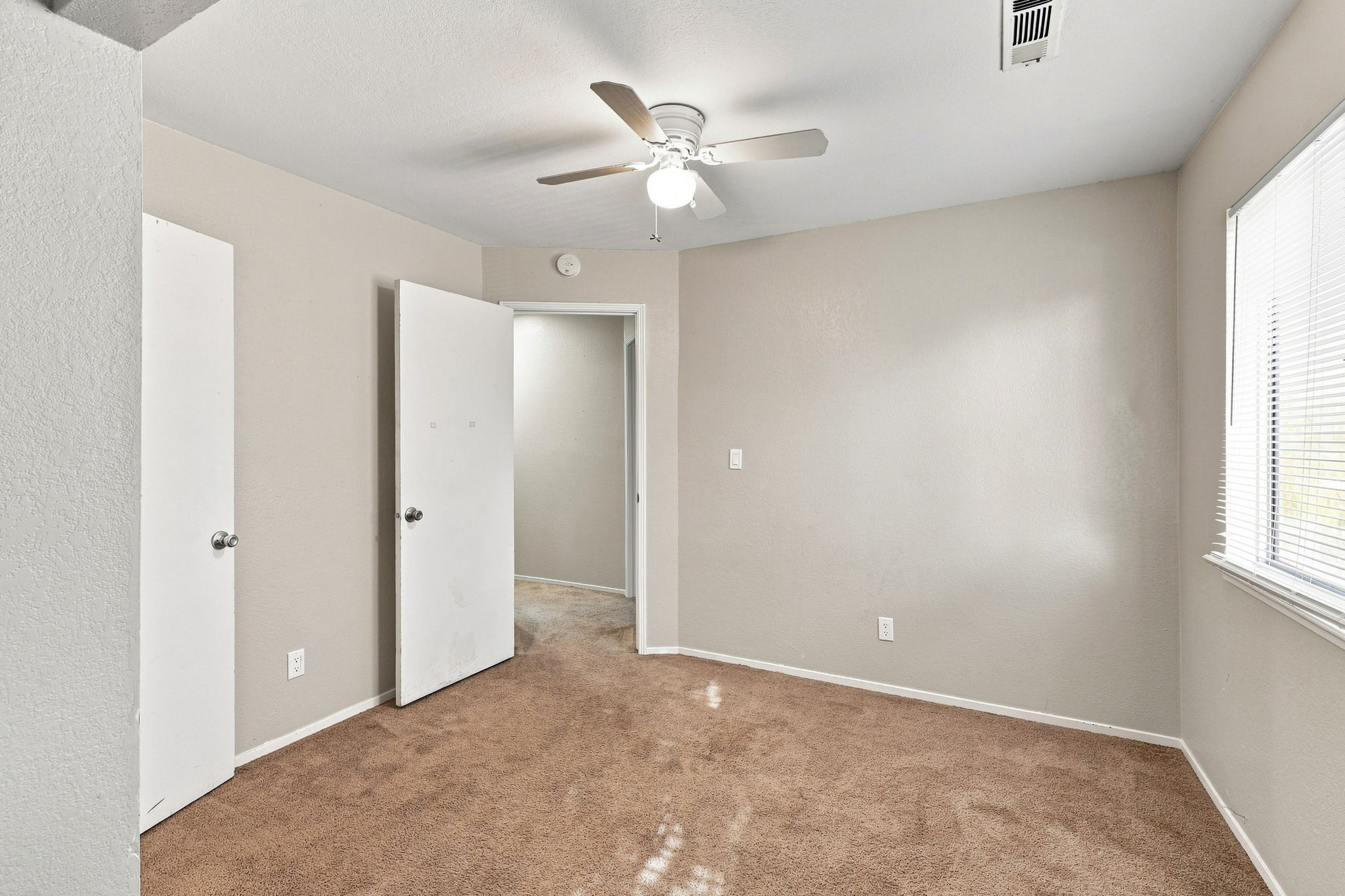 Bedroom 4 with ceiling fan and multiple closets