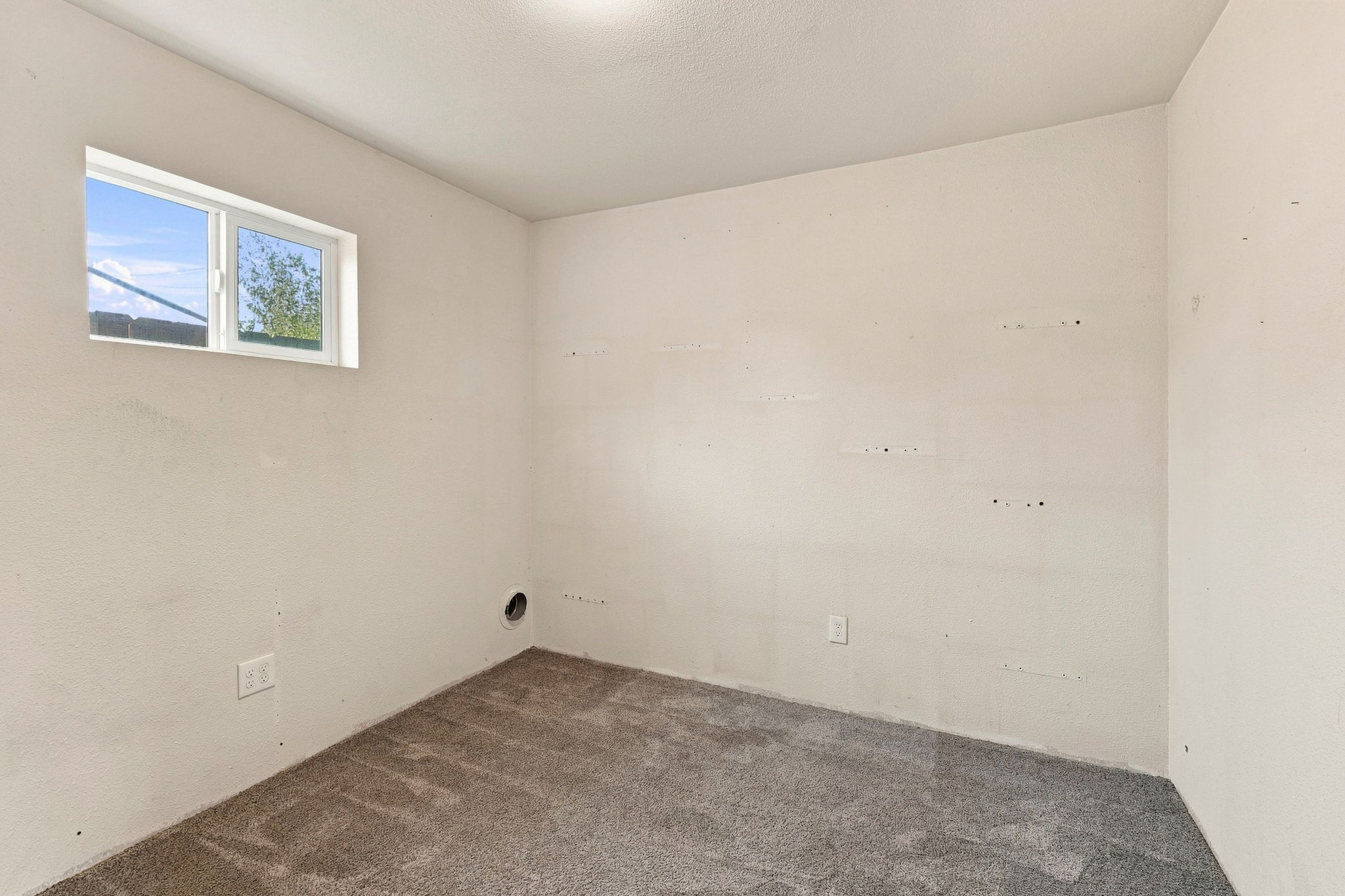 Finished garage bonus room with high window—ideal for an office or flex space