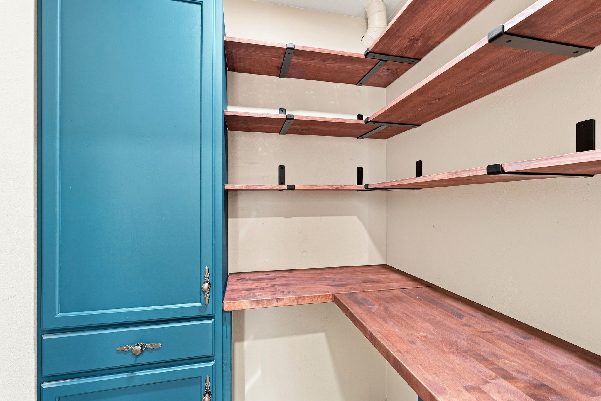 Walk-in pantry with wraparound wood shelving