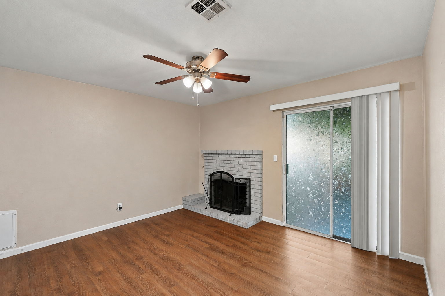 Living room with fireplace and sliding patio access