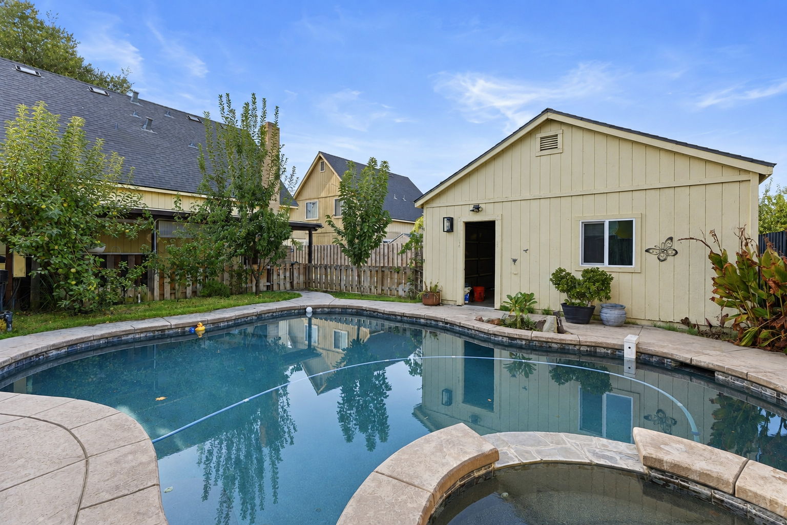 Pool and spa with garage backdrop