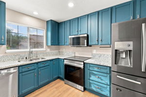 Kitchen workspace with abundant cabinetry and natural light
