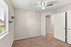 Bedroom 3 with natural light and wall-mounted shelving