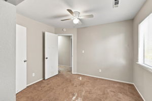 Bedroom 4 with ceiling fan and multiple closets