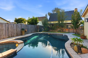Pool and spa with rear exterior view
