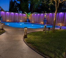 Pool and spa with app-controlled color-changing ambient lighting