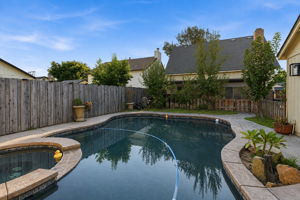 Pool and spa with rear exterior view