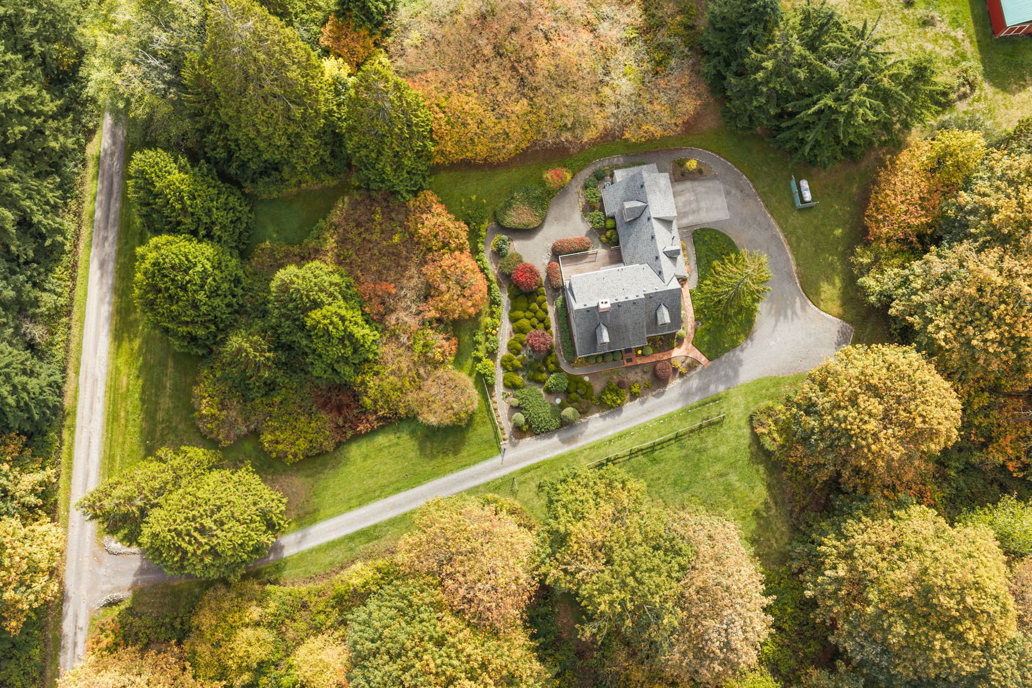 An overhead view showcases the pristine property and a sweeping driveway with room to maneuver.