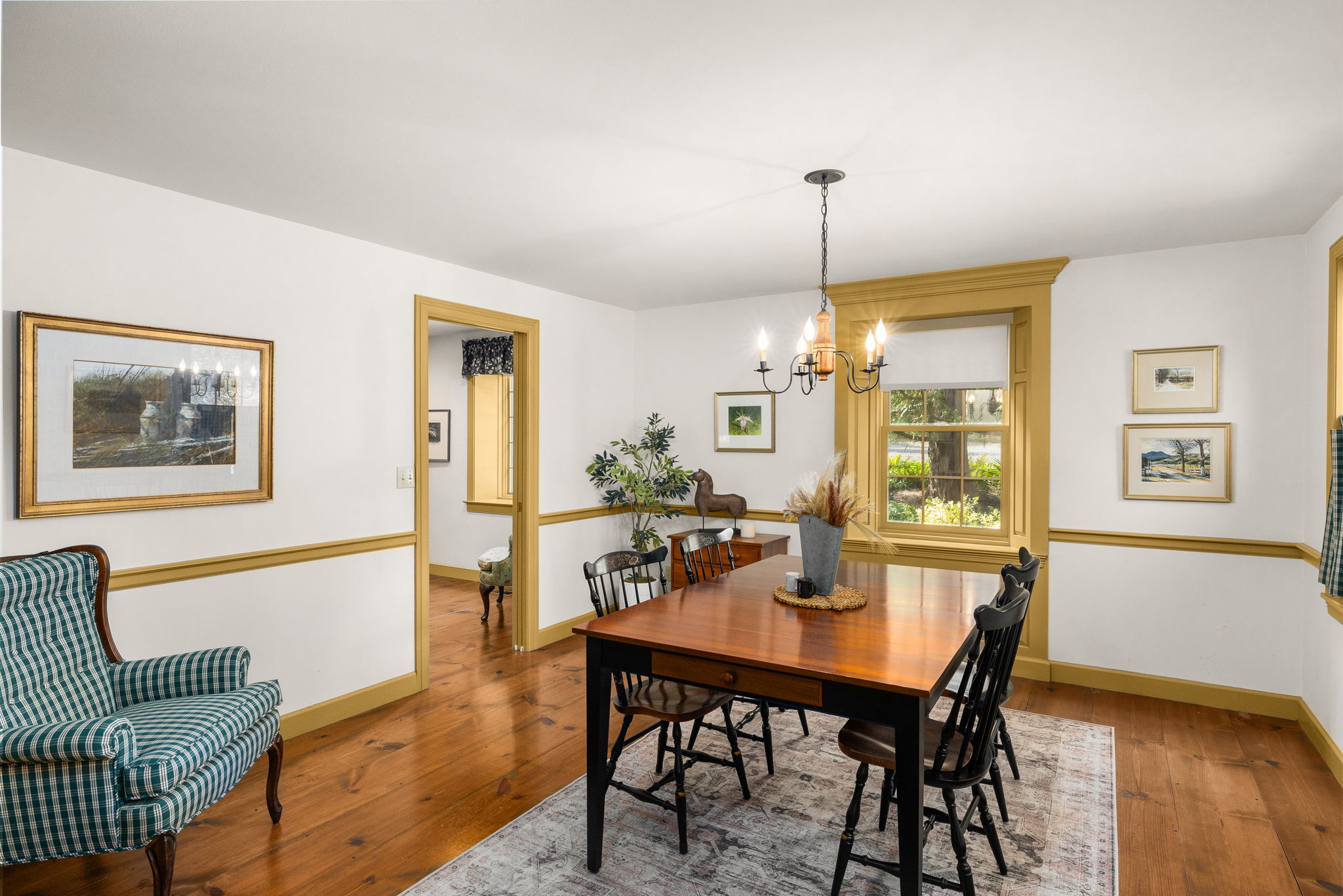 Share meals and linger over conversation in the dining room, with classic trim, wood floors, and garden views.