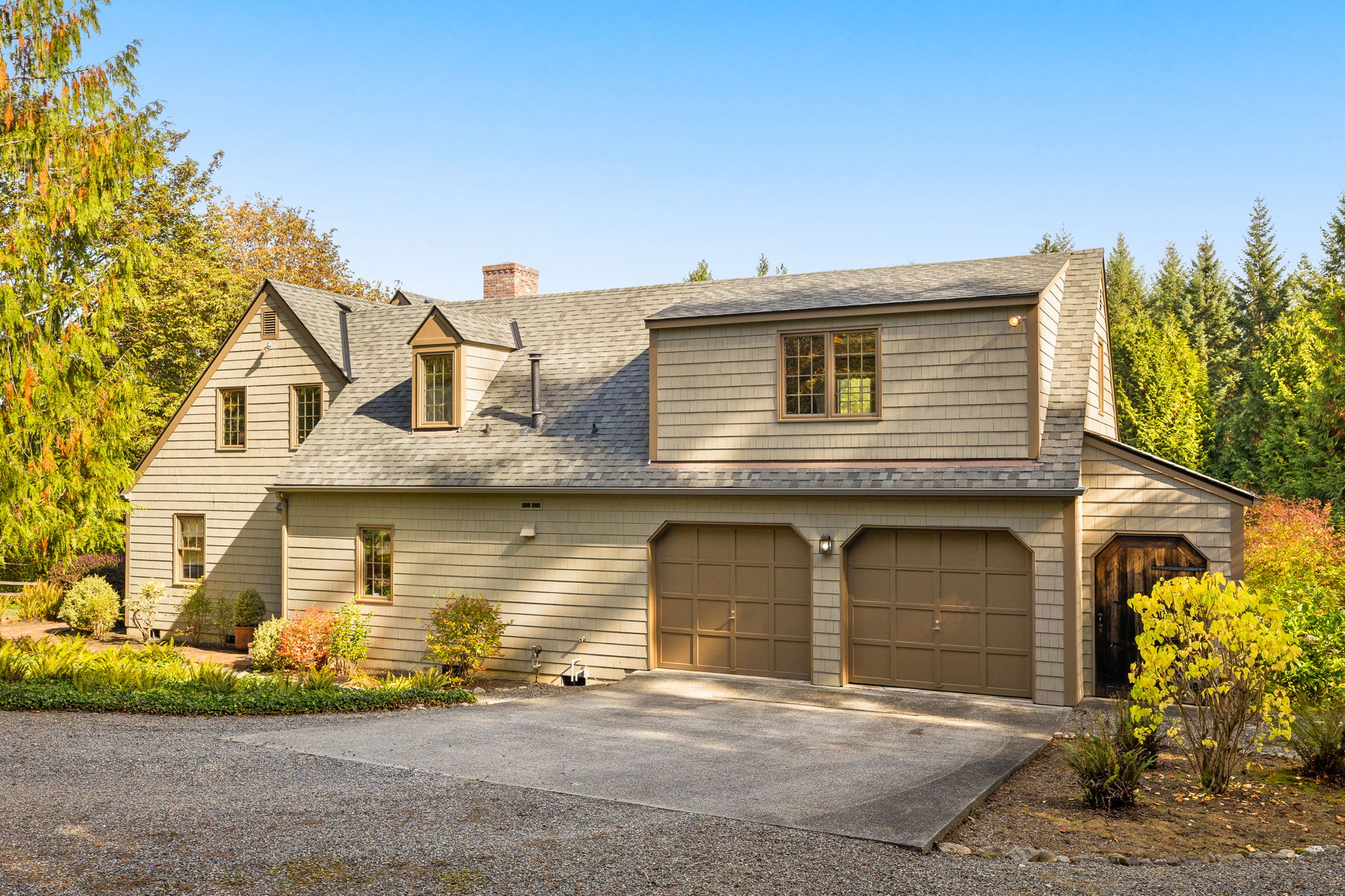 An attached two-car garage and broad driveway provide convenient parking.