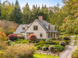 The home comes into view as you approach along its dedicated driveway.