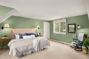 Accessed by a second interior staircase, this separate upstairs wing offers the option of a second primary bedroom, with a small alcove retreat through the door.