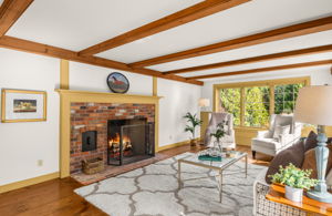 The brick fireplace offers a nod to the past with a decorative cubby for firewood.