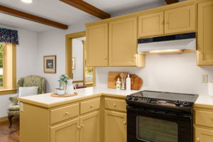 A handy peninsula offers room to prep meals or linger over morning coffee in the kitchen.