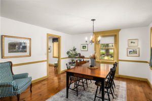 Share meals and linger over conversation in the dining room, with classic trim, wood floors, and garden views.