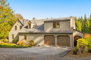 An attached two-car garage and broad driveway provide convenient parking.