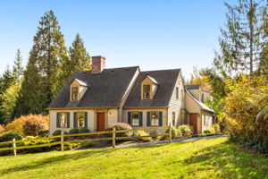 Welcome to this charming Frank Tichy Cape Cod home on five acres, nestled in a peaceful wooded setting.